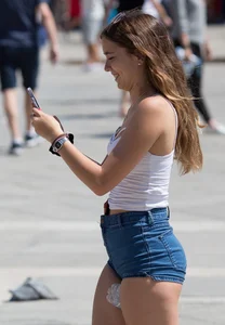 Sexy girl showing her cheeks in tight and tiny denim shorts