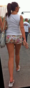 Girl in little floral shorts showing her cheeks