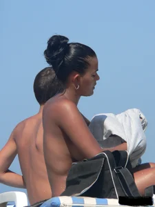 Hot ass topless beach girl with great tits lets her little brother oil up her ass in thong bikini