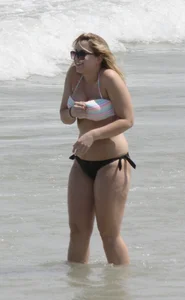 Big boobed thick blonde on the beach in a bikini