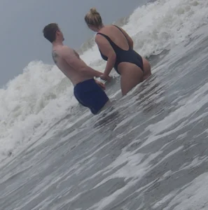 Thick blonde on the beach with a big booty in a blue swimsuit