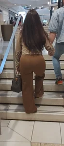 Brunette in brown pants jiggly
