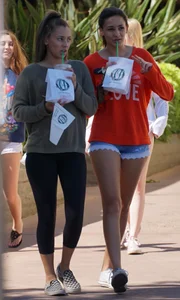 Brunette in tiny shorts walking with her sexy friend in leggings