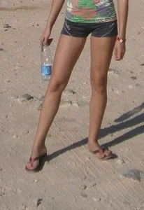 Skinny Candid Teen Girl's Legs, She's Dressed in Tight Mini Shorts And Slippers