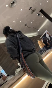 Sexy bubble butt in tight green leggings at the mall
