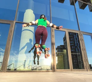 Hot girl in leggigns on roller skates jumping