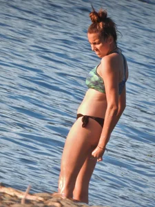 Sexy beach girl in a Nike sports bra and black bikini bottom