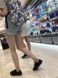 Girl in Blue Denim Shorts with Very Skinny Legs Store Candid