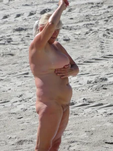 Mature blonde lady on a nude beach with big boobs