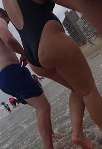 Thick blonde on the beach with a big booty in a blue swimsuit