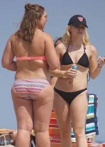 Two thick white girls in bikinis on the beach with big asses