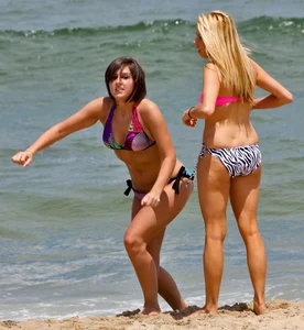 One blonde and one brunette bikini babes at the beach