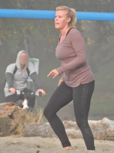 Beach volleyball blonde lady in tight leggings