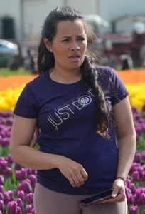 Cute babe in tight leggings taking pictures in flower fields