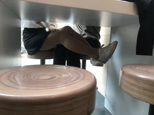 Girl in a Skirt and Pantyhose Touching Herself Under a Table at a Restaurant Creepshots Collection