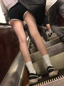 A Tall And Slim Candid Girl in Spandex Shorts in a Hoodie Top, With Tattoos on Her Long Legs Subway Creepshots