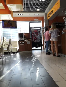 Girl in Mini Shorts and Sandals in a Cafe Candid