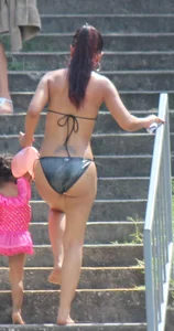 Sexy brunette milf in a bikini with a great body, nice ass and some camel toe