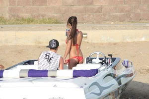 Brunette on a boat in red thong bikini with a tight little ass