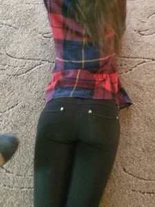 Skinny Girl Lying on the Floor in a Chequered Shirt and Tight Jeans Candid
