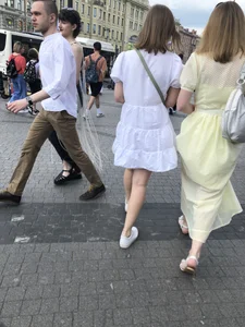 Young candid girl in a white dress, hot legs