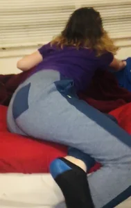 Home creepshot of a girl in pants and socks