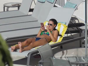 Hot milf sunbathing in a thong by pool and swimming