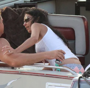Bikini babe on a boat with a wet see through white shirt showing her tits