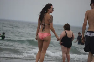 Peach bikini tattood babe on the beach with a nice ass and some camel toe