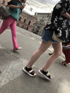 Hot pale legs of a candid girl crossing the street