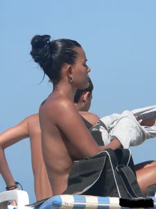 Hot ass topless beach girl with great tits lets her little brother oil up her ass in thong bikini