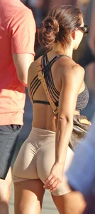 Tanned fitness woman showing off her toned physique & amazing butt