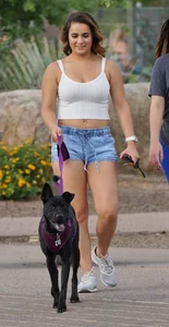 Sexy dog walker in shorts and tank top with friend in blue jeans