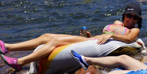 Sexy party girls in bikinis on a lake