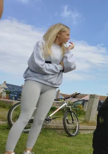 Pretty blonde in white leggings at the beach