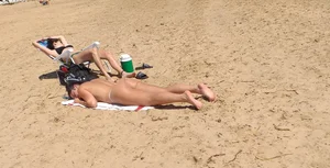 Girl laying out getting sun in a white thong bikini