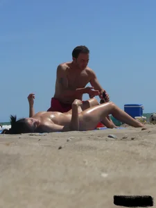 Purple thong topless lady on the beach gets oiled up by her husband