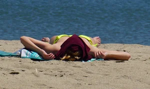 Sexy ass blonde milf on the beach in a thong with cameltoe and bending over