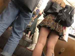 Candid Girl in a Skirt With a Tattoo on Her Calf Subway Escalator Creepshots Gallery