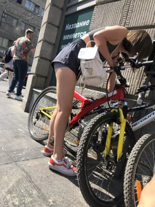 Bike girl's hot slim legs and booty in shorts