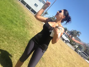 Hot brunette babe in leggings walking her dog with a nice ass and some cleavage