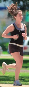 Cute girl running in short shorts