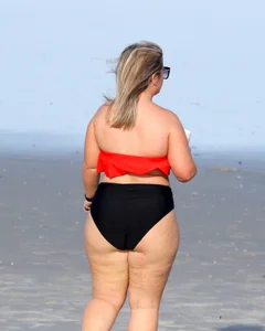 Thick BBW blonde lady in a bikini at the beach