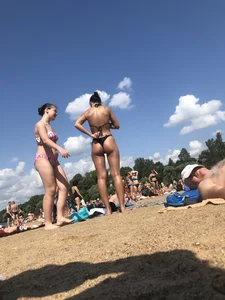 Gorgeous milf rubbing sun lotion in her skin at the beach, with a couple of her milf friends