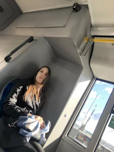 Extremely cute girl in leggings sitting in a public bus