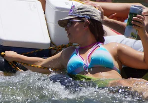 Sexy party girls in bikinis on a lake