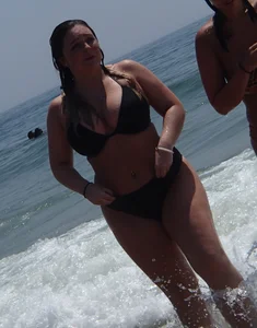Thick beach babe with big tits in a thong bikini