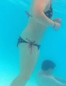 Underwater shots of a bikini teen swimming in the pool