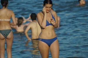 Girl with Wide Pelvis and Thin Waist in Blue Swimsuit Walking on Sand by the Water Beach Creepshots