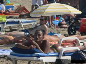 Hot ass topless beach girl with great tits lets her little brother oil up her ass in thong bikini